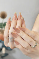 24 handmade almond nails Sheer nude base with metallic gold gradient french tip