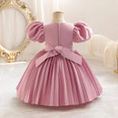 Pink dress with puffed sleeves on a mannequin against a decorative background, Obroi