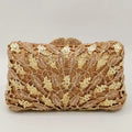 Gold clutch with intricate design on a light gray background, Obroi