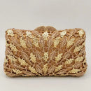 Gold clutch with intricate design on a light gray background, Obroi