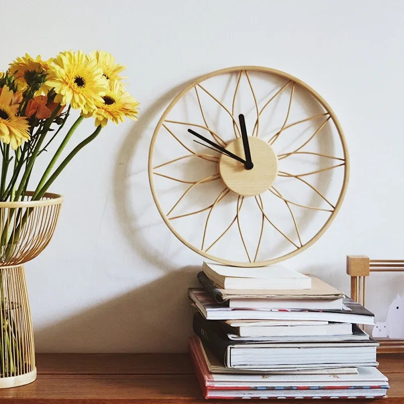 Decorative clock on a stack of books with yellow flowers in the background, Obroi