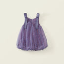 A toddler girl's sleeveless tutu dress in lavender purple, featuring a sparkly glittery tulle body and matching purple shoulder straps, shown against a solid light beige background, Obroi