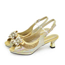 Gold high-heeled shoes with decorative elements on a white background, Obroi