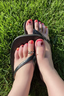 Close-up of toes with colorful nail art on grass background, Obroi