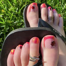Close-up of toes with colorful nail art on grass background, Obroi