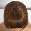 Close-up of a person's head with brown hair on a neutral , Obroi
