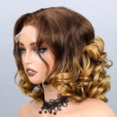A brown and blonde ombré wig with wavy curls, styled on a mannequin head against a light gray background. The brand name 'Obroi' is visible in the top left corner.