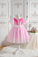 Pink princess dress on a mannequin against a decorative white wall, Obroi