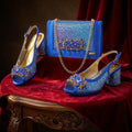 Blue embellished shoes and handbag on a red fabric background, Obroi