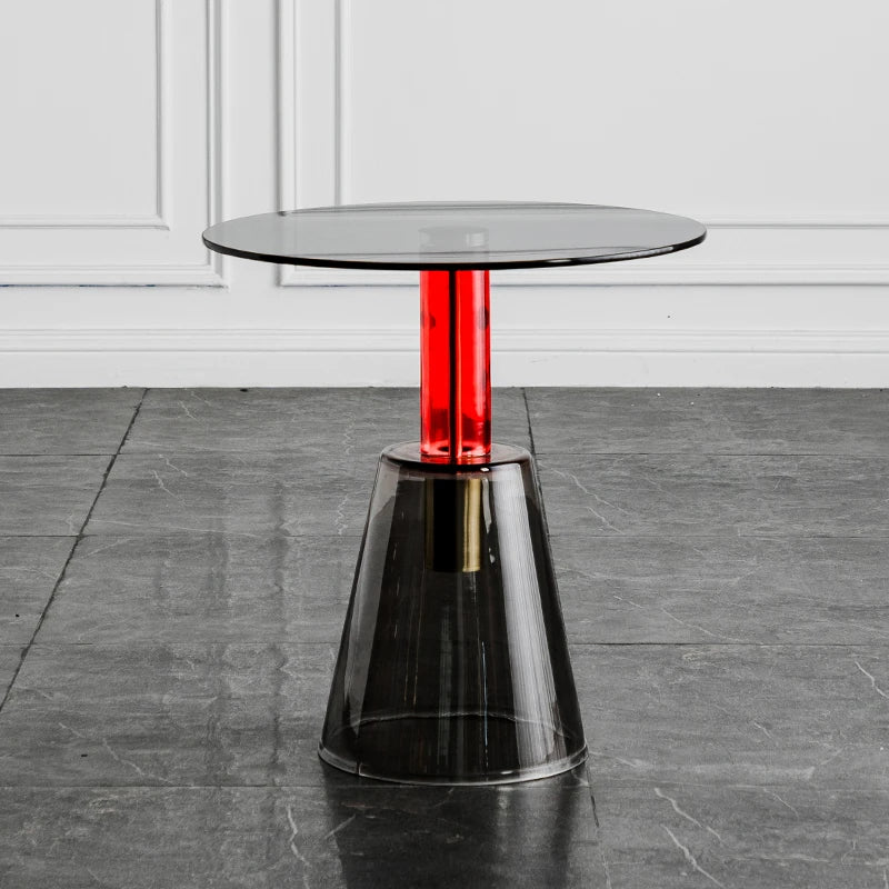 Modern glass table with a red central column on a gray floor, Obroi