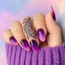 Hand with purple gradient nails and a tattoo on a pastel background, Obroi