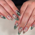 Close-up of hands with decorative nail art featuring flowers and stars on a neutral background, Obroi