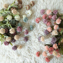 Assorted flowers on a white fluffy surface, Obroi