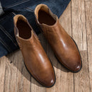 Brown leather boots on a wooden floor with jeans ,Obroi