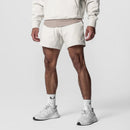 Person wearing white athletic shorts and shoes on a plain background, Obroi