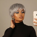 Woman with short gray hair holding a phone against a beige background, Obroi