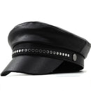 Black leather cap with decorative studs on a white background