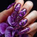 Nails with purple floral design on a dark background, Obroi