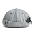 Gray denim cap with worn edges on a white background, Obroi
