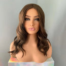 Mannequin head with a brown wig on a gray background, Obroi