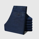 Folded blue jeans with Obroi branding on a light gray background