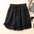 Black shorts with lace trim on a beige background, Obroi