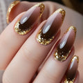 Nails with gold glitter and brown gradient design on a neutral background ,Obroi
