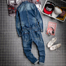 Blue denim jumpsuit on a tiled floor with sneakers and decorative items, Obroi