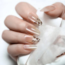 Nails with a nude color and leopard print design on a white background, Obroi