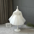 White lace dress on a mannequin against a gray wall, Obroi