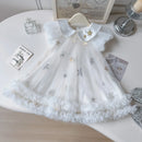 White lace dress with star patterns on a white surface, Obroi