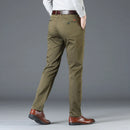Person wearing olive green pants with a gray background, Obroi