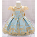 Light blue dress with gold embroidery on a mannequin against a white background, Obroi