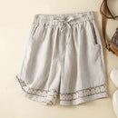 Light gray shorts with lace trim on a beige background, Obroi
