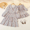 Two matching polka dot dresses on hangers with a straw hat and shoes on a light background, Obroi
