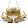 Gold shoes and handbag set with intricate designs on a white background, Obroi