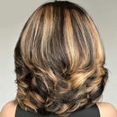 A woman's shoulder-length wavy hair with dark brown and warm blonde balayage highlights, shown from the back. The 'Obroi' logo is visible in the top left corner.