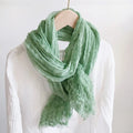 Green scarf on a mannequin against a white background, Obroi