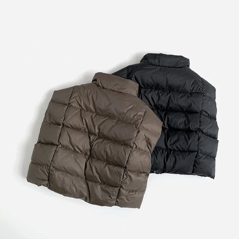 Two puffer vests, one brown and one black, on a light gray background with 'Obroi' branding.