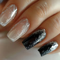Close-up of a hand with black and silver glittery nail polish on a neutral background, Obroi