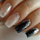 Close-up of a hand with black and silver glittery nail polish on a neutral background, Obroi