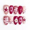Set of handmade nails with various designs including stars and flowers on a white background, Obroi