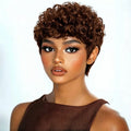Woman with short, curly brown hair wearing a brown dress against a white background, Obroi