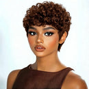 Woman with short, curly brown hair wearing a brown dress against a white background, Obroi