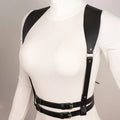 Mannequin wearing a white top with black leather suspenders against a neutral background, Obroi