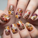 Nails with autumn-themed floral and swirl designs, Obroi
