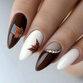 Nails with brown and white design featuring leaf patterns on a neutral background, Obroi