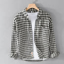 Black and white checkered shirt on a hanger against a gray background, Obroi
