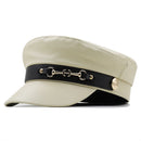 Beige cap with black band featuring gold hardware on a white background, Obroi