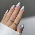Hand with silver glittery nails and gold rings on a neutral background,Obroi